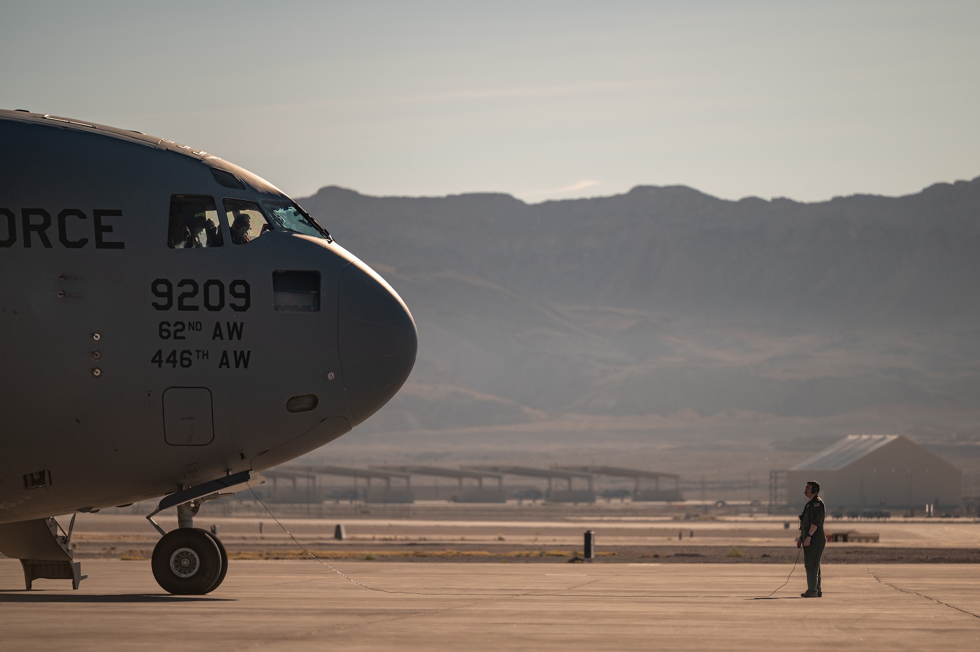 a person stands in front of an aircraft