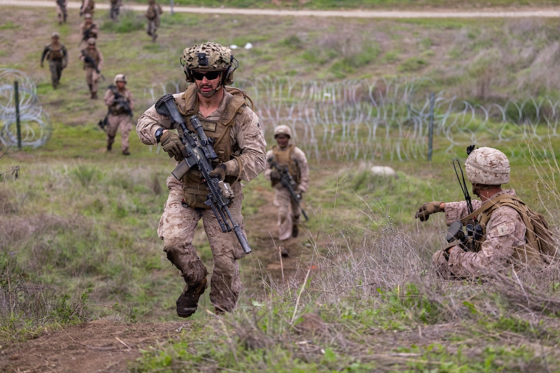 U.S. Marines with Blackfoot Company, 1st Battalion, 5th Marine Regiment, 1st Marine Division, close in on an objective during a combat readiness evaluation at Marine Corps Base Camp Pendleton, California, Dec. 14, 2025. The purpose of the evaluation was to certify 1st Bn., 5th Marines as the ground combat element for their upcoming deployment. (U.S. Marine Corps photo by Sgt. Kyle Chan)