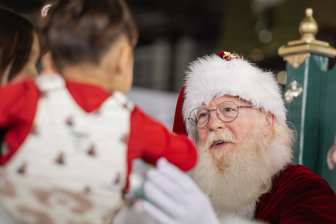 Santa Claus speaks with children at a Toys for Tots charity event on Marine Corps Base Quantico, Virginia, Dec. 8, 2025. Since 1947, the Marine Corps Reserve has spearheaded the Toys for Tots program nationwide to collect toys for less fortunate children during the holiday season. Presently, the program distributes 7 to 18 million toys to children annually. (U.S. Marine Corps photo by Lance Cpl. Van Hoang)