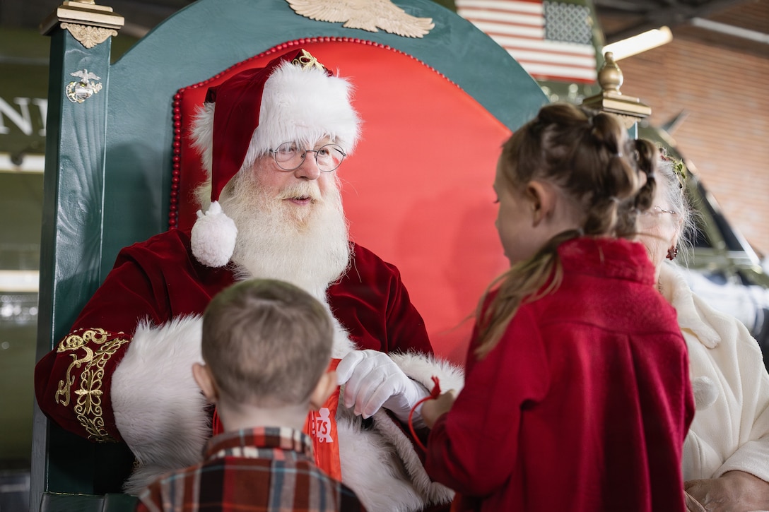Santa Claus speaks with children at a Toys for Tots charity event on Marine Corps Base Quantico, Virginia, Dec. 8, 2025. Since 1947, the Marine Corps Reserve has spearheaded the Toys for Tots program nationwide to collect toys for less fortunate children during the holiday season. Presently, the program distributes 7 to 18 million toys to children annually. (U.S. Marine Corps photo by Lance Cpl. Van Hoang)