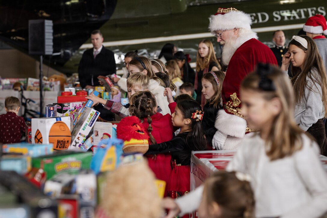 Children move to sort toys during a Toys for Tots charity event on Marine Corps Base Quantico, Virginia, Dec. 8, 2025. Since 1947, the Marine Corps Reserve has spearheaded the Toys for Tots program nationwide to collect toys for less fortunate children during the holiday season. Presently, the program distributes 7 to 18 million toys to children annually. (U.S. Marine Corps photo by Lance Cpl. Van Hoang)