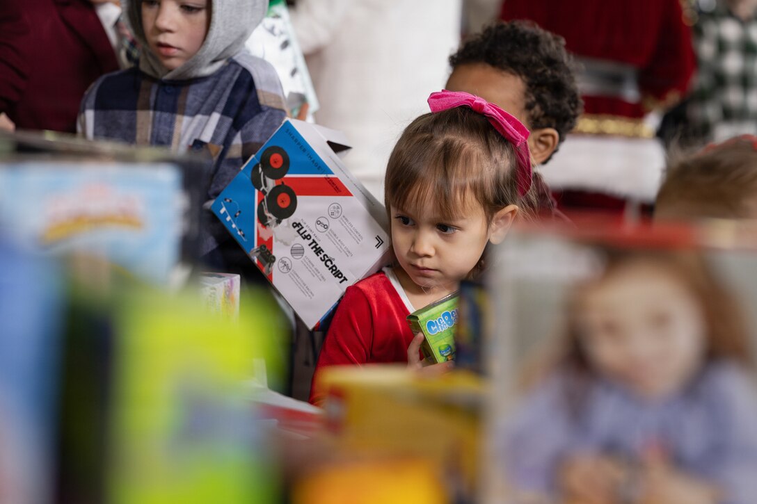 A child grabs a toy during a Toys for Tots charity event on Marine Corps Base Quantico, Virginia, Dec. 8, 2025. Since 1947, the Marine Corps Reserve has spearheaded the Toys for Tots program nationwide to collect toys for less fortunate children during the holiday season. Presently, the program distributes 7 to 18 million toys to children annually. (U.S. Marine Corps photo by Lance Cpl. Van Hoang)