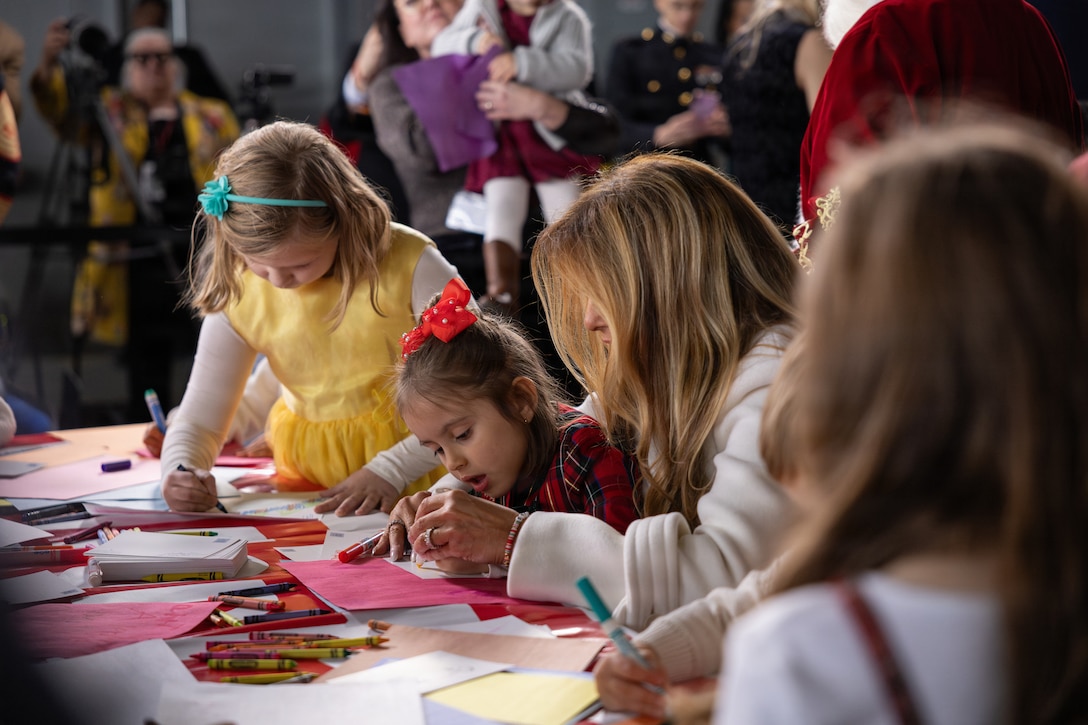 First lady of the United States, Melania Trump, draws and writes Christmas cards with children during a Toys for Tots charity event on Marine Corps Base Quantico, Virginia, Dec. 8, 2025. Since 1947, the Marine Corps Reserve has spearheaded the Toys for Tots program nationwide to collect toys for less fortunate children during the holiday season. Presently, the program distributes 7 to 18 million toys to children annually. (U.S. Marine Corps photo by Lance Cpl. Van Hoang)