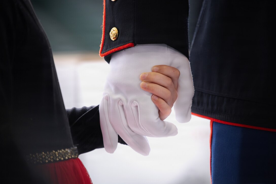 A child holds the hand of her father during a Toys for Tots charity event on Marine Corps Base Quantico, Virginia, Dec. 8, 2025. Since 1947, the Marine Corps Reserve has spearheaded the Toys for Tots program nationwide to collect toys for less fortunate children during the holiday season. Presently, the program distributes 7 to 18 million toys to children annually. (U.S. Marine Corps photo by Lance Cpl. Van Hoang)