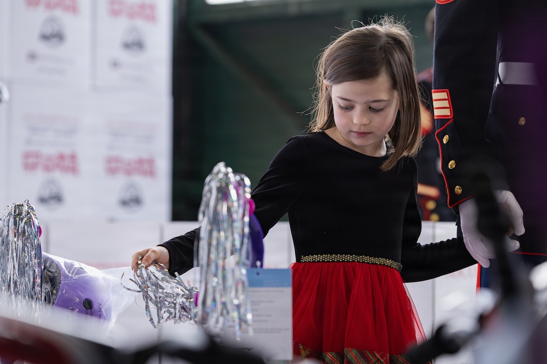 A child looks at new bicycles during a Toys for Tots event on Marine Corps Base Quantico, Virginia, Dec. 8, 2025. Since 1947, the Marine Corps Reserve has spearheaded the Toys for Tots program nationwide to collect toys for less fortunate children during the holiday season. Presently, the program distributes 7 to 18 million toys to children annually. (U.S. Marine Corps photo by Lance Cpl. Van Hoang)