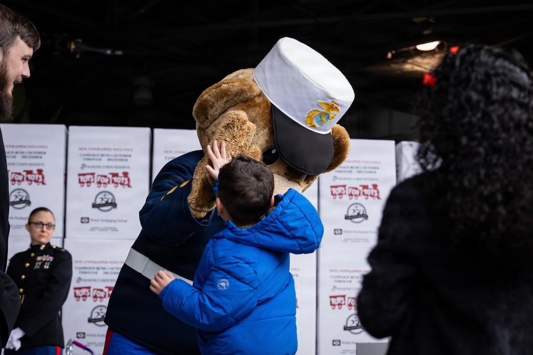 Gunny Bear greets guests during a Toys for Tots charity event on Marine Corps Base Quantico, Virginia, Dec. 8, 2025. Since 1947, the Marine Corps Reserve has spearheaded the Toys for Tots program nationwide to collect toys for less fortunate children during the holiday season. Presently, the program distributes 7 to 18 million toys to children annually. (U.S. Marine Corps photo by Lance Cpl. Van Hoang)