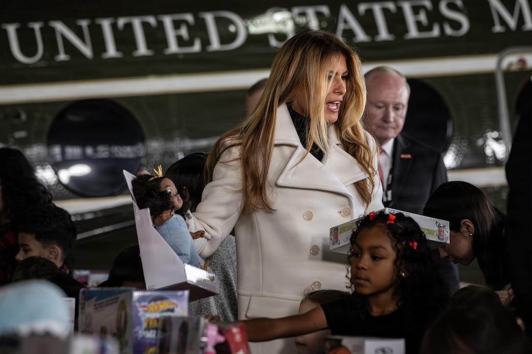 First lady of the United States, Melania Trump, helps move donated gifts during a Toys for Tots charity event on Marine Corps Base Quantico, Virginia, Dec. 8, 2025. Since 1947, the Marine Corps Reserve has spearheaded the Toys for Tots program nationwide to collect toys for less fortunate children during the holiday season. Presently, the program distributes 7 to 18 million toys to children annually. (U.S. Marine Corps photo by Lance Cpl. Van Hoang)