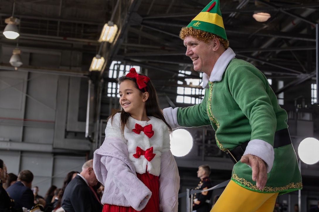 Buddy the elf greets children at a Toys for Tots charity event on Marine Corps Base Quantico, Virginia, Dec. 8, 2025. Since 1947, the Marine Corps Reserve has spearheaded the Toys for Tots program nationwide to collect toys for less fortunate children during the holiday season. Presently, the program distributes 7 to 18 million toys to children annually. (U.S. Marine Corps photo by Lance Cpl. Van Hoang)