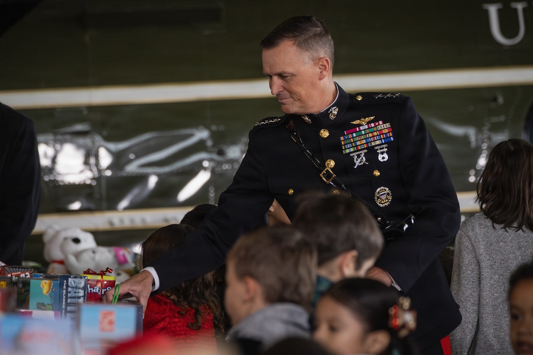 U.S. Marine Corps Lt. Gen. Leonard F. Anderson IV, commander, Marine Forces Reserve and Marine Forces South, helps move donated gifts during a Toys for Tots charity event on Marine Corps Base Quantico, Virginia, Dec. 8, 2025. Since 1947, the Marine Corps Reserve has spearheaded the Toys for Tots program nationwide to collect toys for less fortunate children during the holiday season. Presently, the program distributes 7 to 18 million toys to children annually. (U.S. Marine Corps photo by Lance Cpl. Van Hoang)