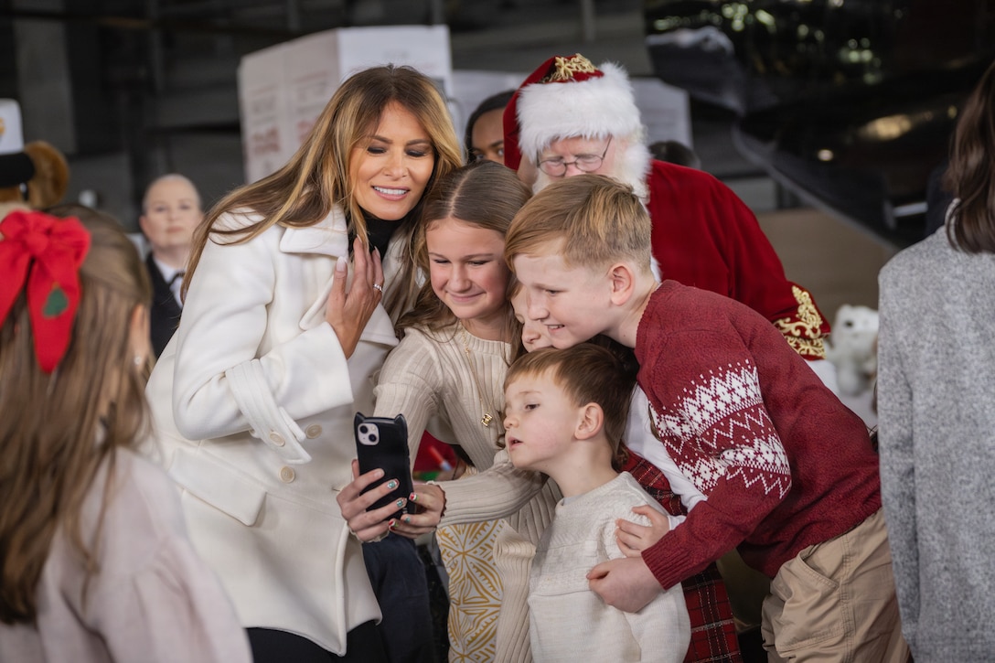 First lady of the United States, Melania Trump, left, takes a selfie with children during a Toys for Tots charity event on Marine Corps Base Quantico, Virginia, Dec. 8, 2025. Since 1947, the Marine Corps Reserve has spearheaded the Toys for Tots program nationwide to collect toys for less fortunate children during the holiday season. Presently, the program distributes 7 to 18 million toys to children annually. (U.S. Marine Corps photo by Lance Cpl. Van Hoang)