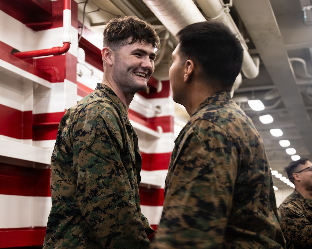 U.S. Marine Corps Lance Cpl. Joseph Newman, a rifleman with Lima Company, Battalion Landing Team 3/5, 11th Marine Expeditionary Unit, is congratulated by his peers during a promotion ceremony in the well deck of San Antonio-class amphibious transport dock ship USS Portland (LPD 27), in the Pacific Ocean, Dec. 7, 2025. The 11th MEU is currently underway aboard the Boxer Amphibious Ready Group in the U.S. 3rd Fleet area of operations conducting integrated training that enhances lethality and warfighting readiness. (U.S. Marine Corps photo by Lance Cpl. Luke Rodriguez)