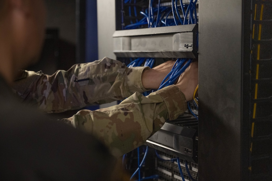 U.S. Air Force Airman 1st Class Brycen Howell, 97th Communications Squadron (CS) network technician, navigates cords in the Network Control Center at Altus Air Force Base, Oklahoma, Dec. 18, 2025. Howell took part in the hands-on immersion tour with the 97th CS led by Col. Richard Kind, 97th Air Mobility Wing commander. (U.S. Air Force photo by Airman 1st Class Emma Wright)
