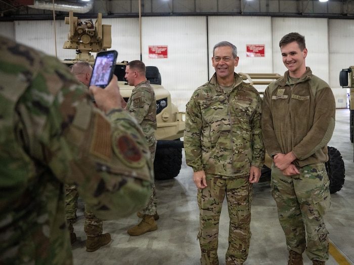 Air Force Chief of Staff Gen. Ken Wilsbach poses for a photo with U.S. Air Force Airman 1st Class James Skinner, 48th Operations Support Squadron airfield management apprentice, during a visit to RAF Lakenheath, England, Dec. 19, 2025.