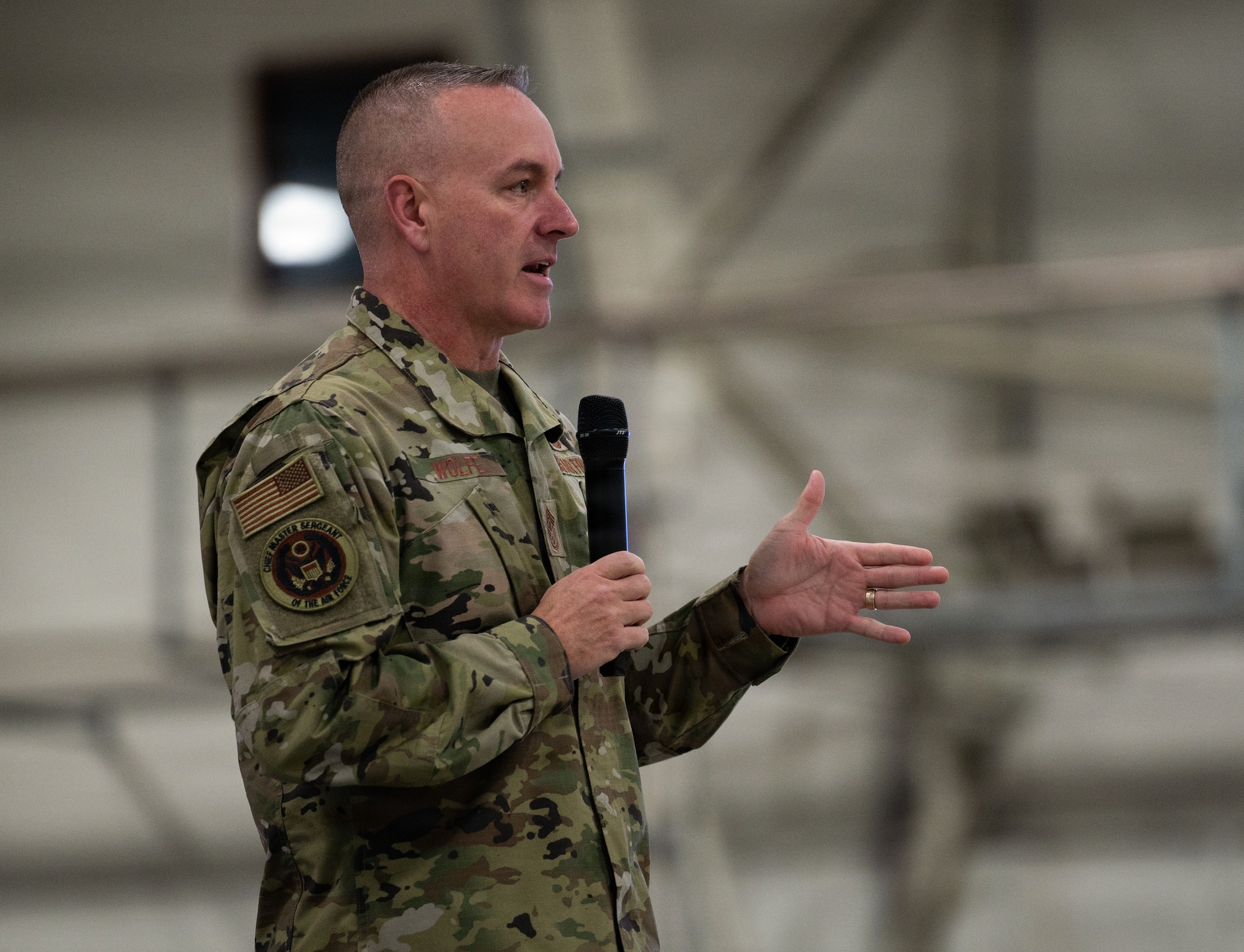 Chief Master Sgt. of the Air Force David Wolfe addresses a crowd of airmen assigned to the 48th Fighter Wing during a visit to RAF Lakenheath, England, Dec. 19, 2025.