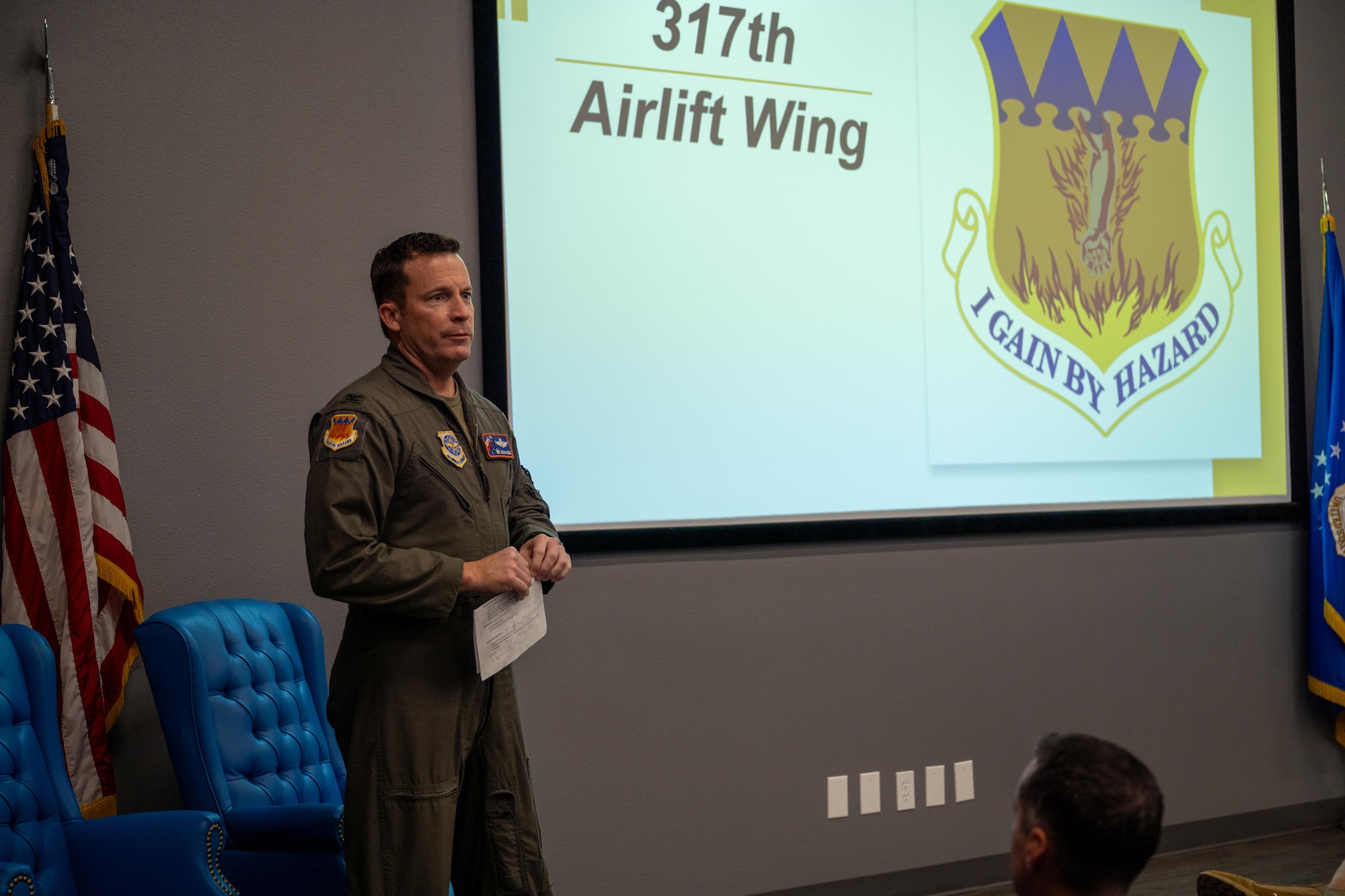 U.S. Air Force Col. Justin Diehl, 317th Airlift Wing commander, briefs Dyess honorary commanders and civic leaders during a townhall at Dyess Air Force Base, Texas, Dec. 17, 2025. The event provided Dyess leadership with the opportunity to highlight operational successes from the past year and discuss priorities for 2026.  (U.S. Air Force photo by Airman 1st Class Adrien Tran)