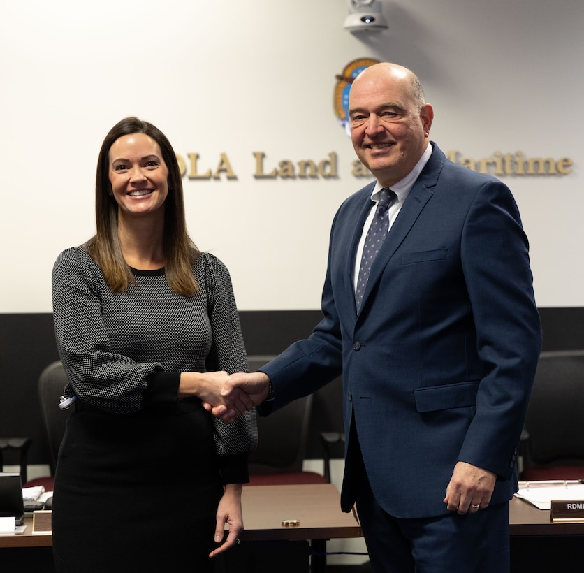 A man and a woman shake hands.