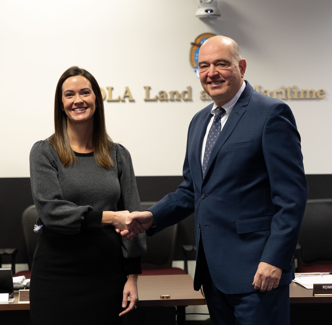 A man and a woman shake hands.