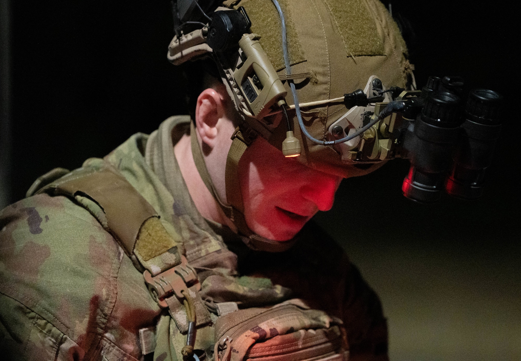 A close up shot of an Airman looking down at a manual.
