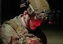 A close up shot of an Airman looking down at a manual.