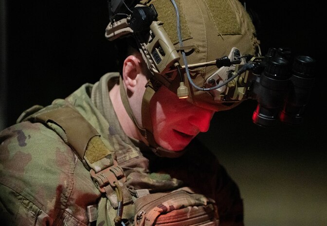 A close up shot of an Airman looking down at a manual.