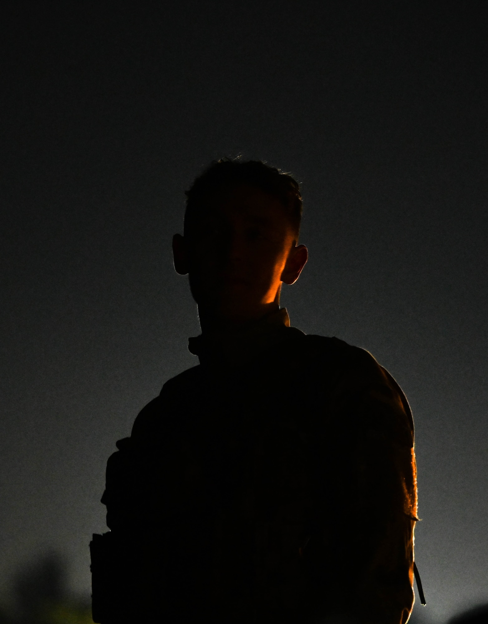 A silhouette of an Airman preparing for enemy recon.