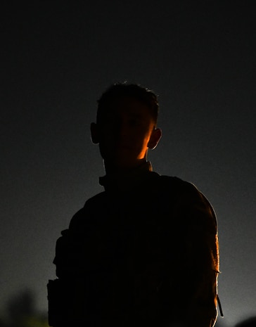 A silhouette of an Airman preparing for enemy recon.