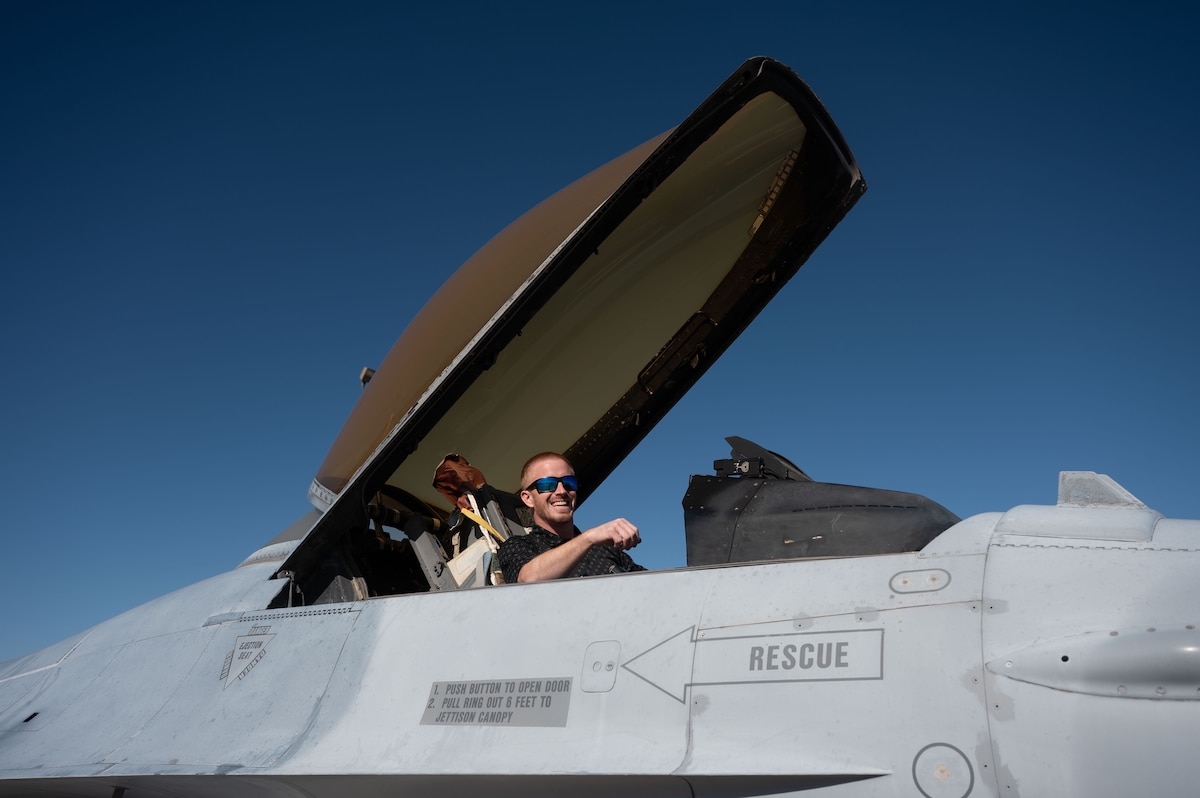Lane Carter, Tom Green County judge, sits in the cockpit of an F-16 Fighting Falcon aircraft during an immersion at the Louis F. Garland Department of War Fire Academy, Goodfellow Air Force Base, Texas, Dec. 12, 2025. The HCC viewed an F-16 aircraft training model utilized by the Louis F. Garland Department of War Fire Academy, highlighting how the airframe supports emergency response training and familiarization with the aircraft. (U.S. Air Force photo by Airman 1st Class James Salellas)
