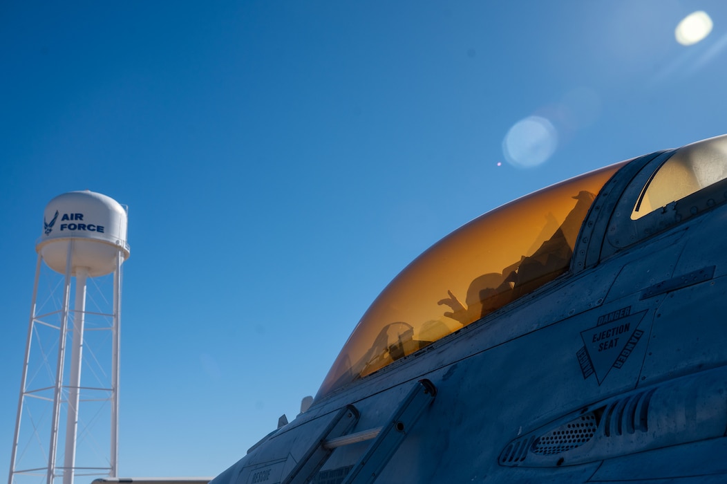 A 17th Training Wing honorary commander sits in the cockpit of an F-16 Fighting Falcon aircraft during an immersion at the Louis F. Garland Department of War Fire Academy, Goodfellow Air Force Base, Texas, Dec. 12, 2025. The aircraft is used as a training aid to familiarize firefighters with emergency response procedures. (U.S. Air Force photo by Airman 1st Class James Salellas)