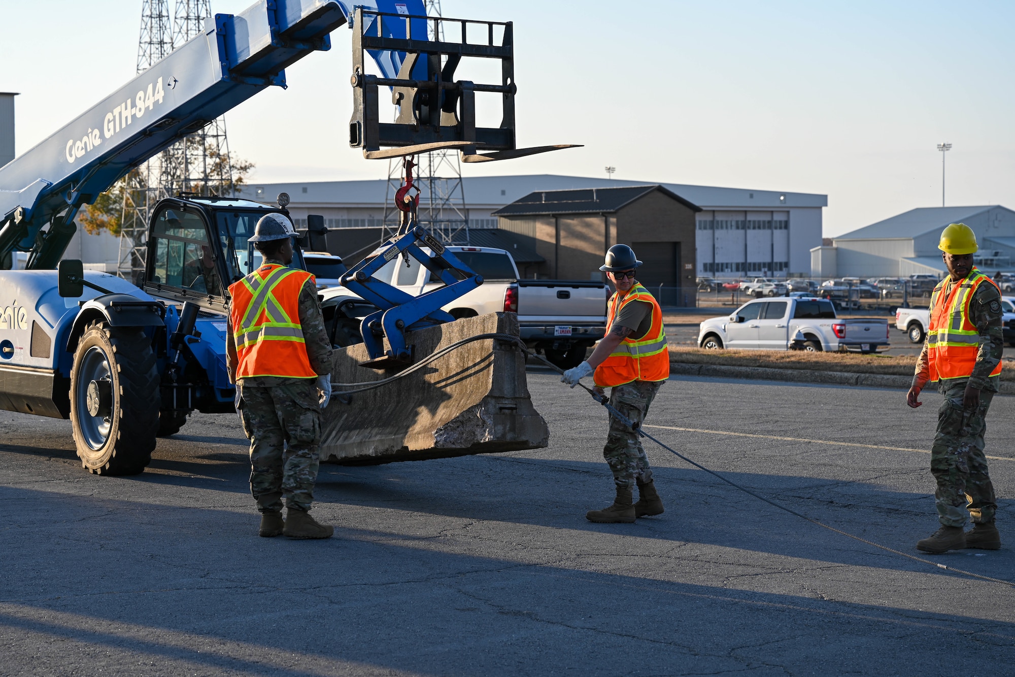 Airmen move a barricade into place during an exercise.