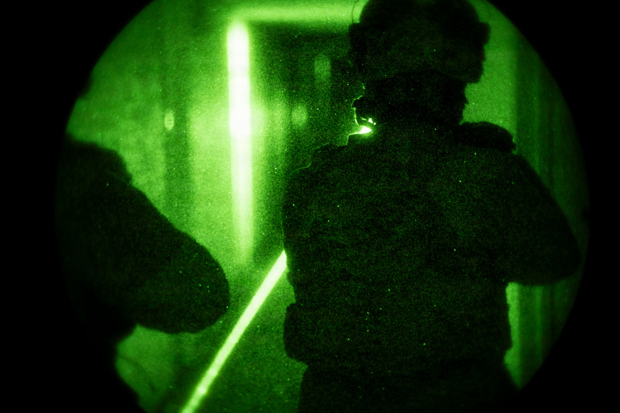 Airman clearing the hall through night vision.
