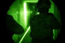 Airman clearing the hall through night vision.