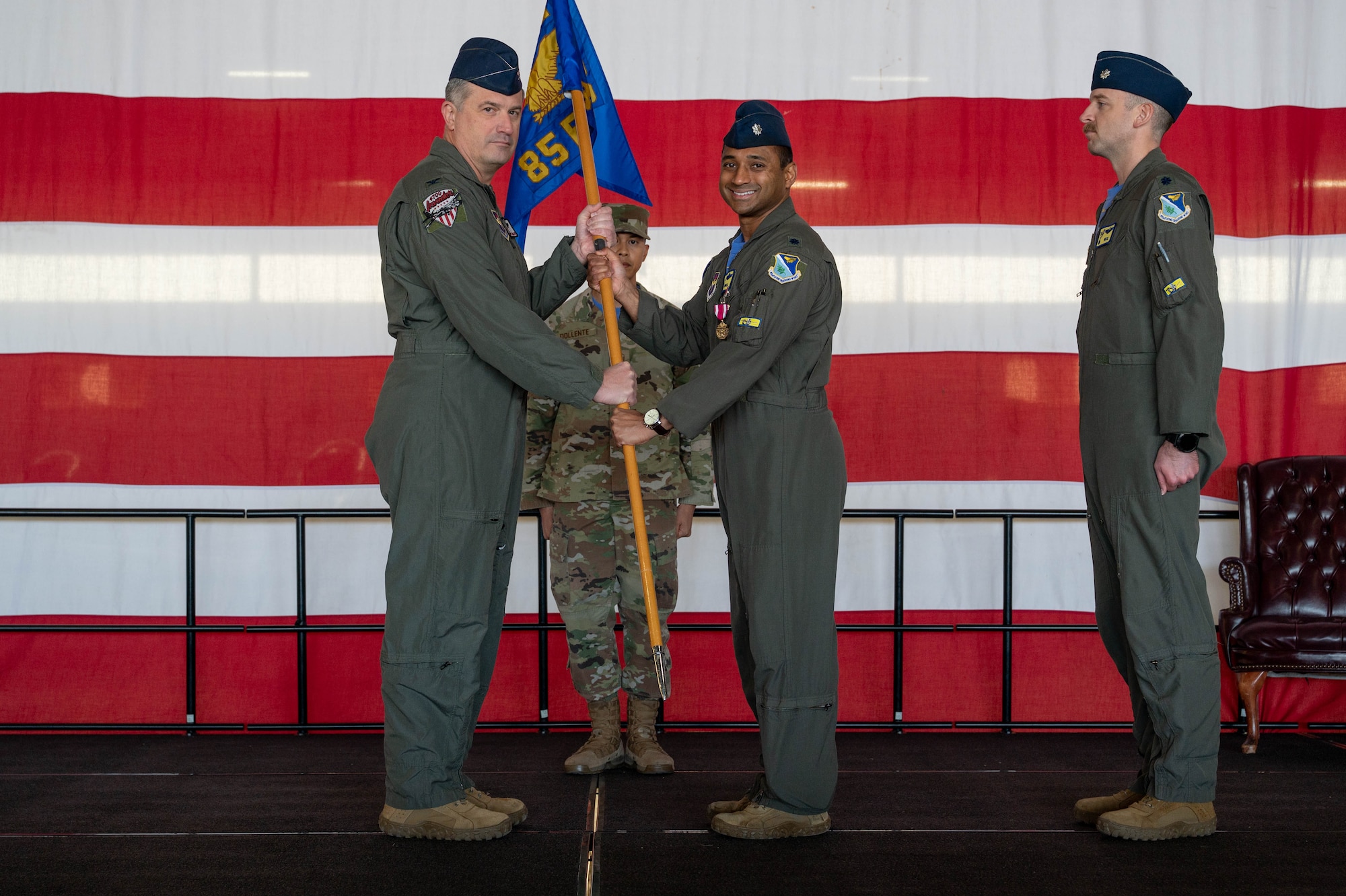 Service members pass squadron guidon.