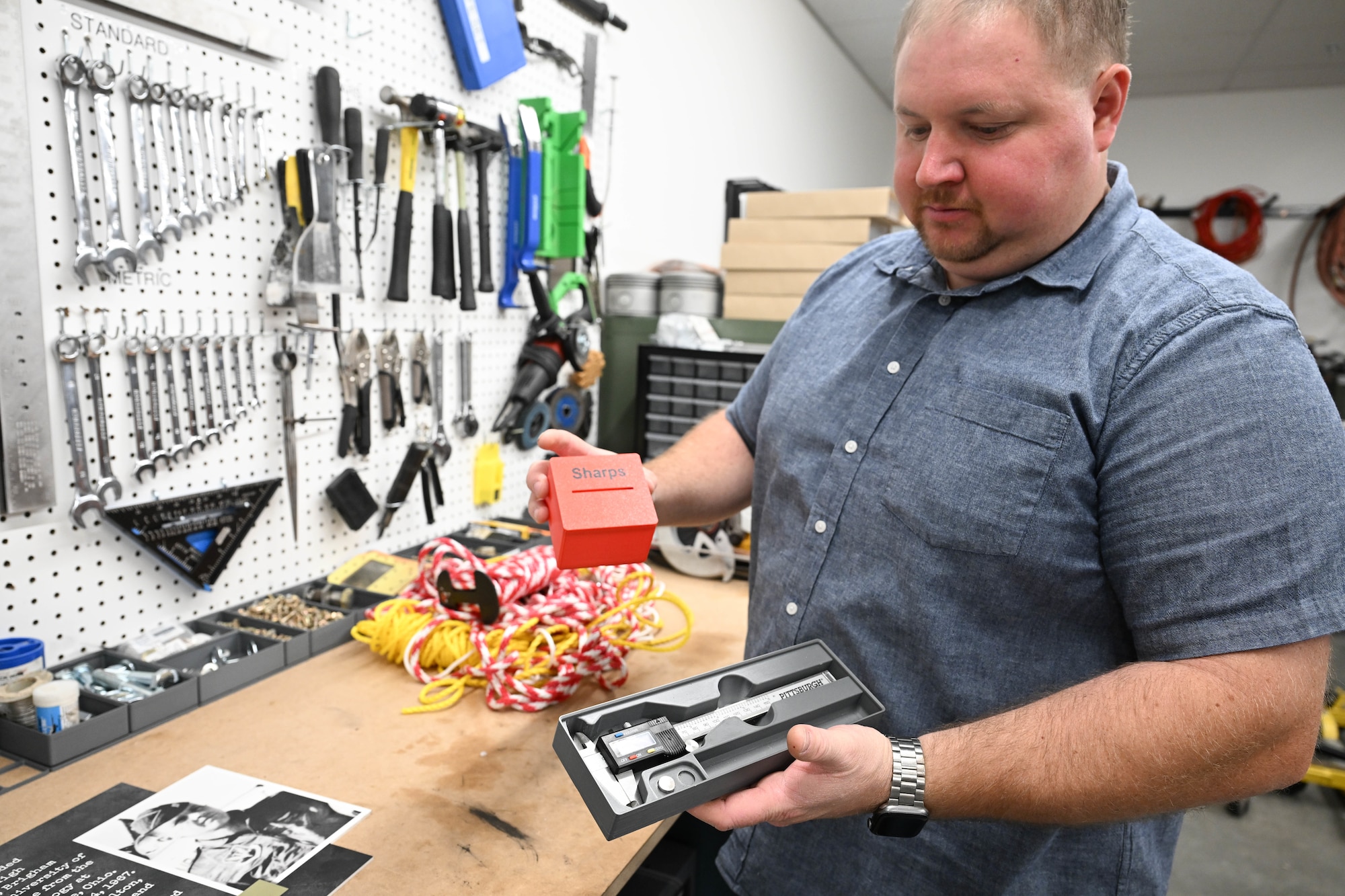 A man holds a 3D printed organizational piece