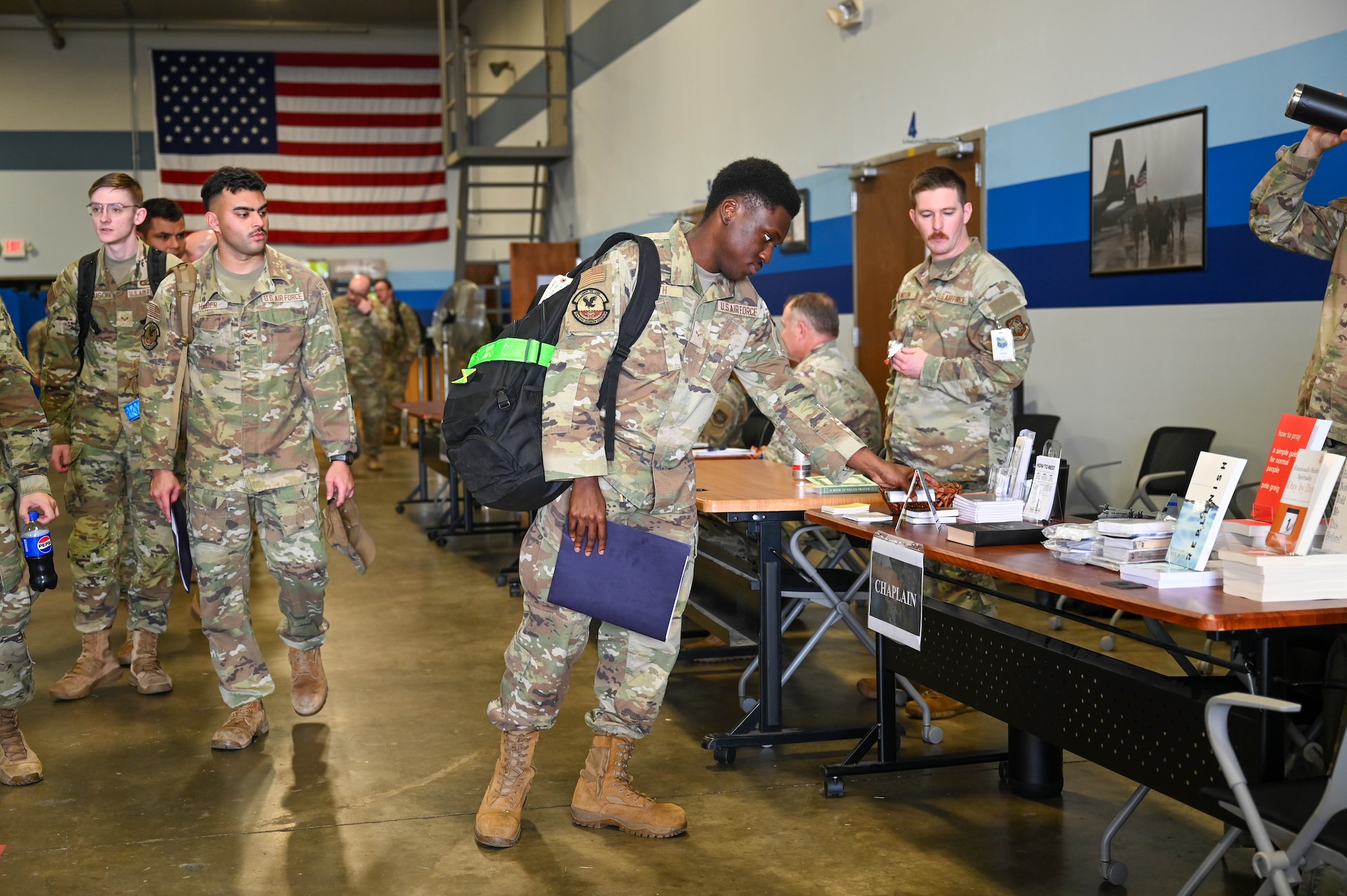 Airman process through a simulated deployment line and pass various helping agencies.