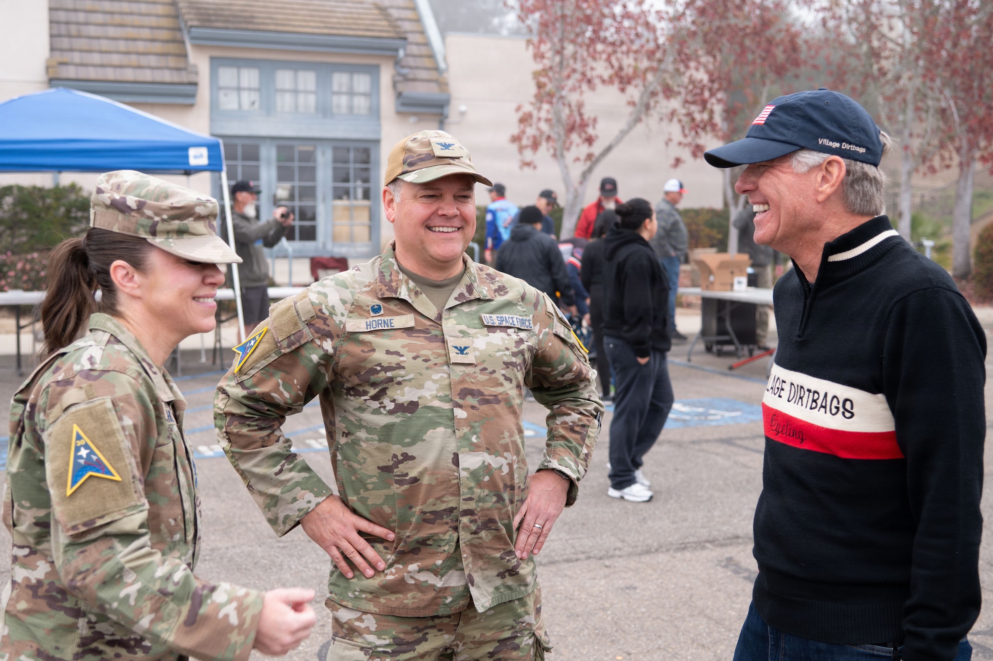 three people stand in a semi circle and talk to each other