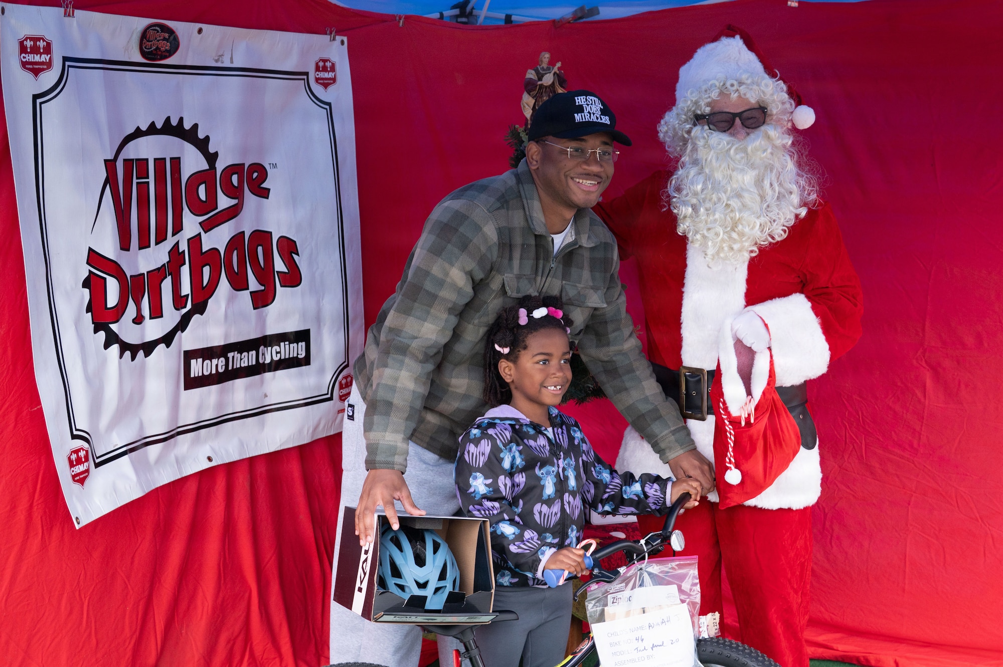 two people pose with a bike for a photo