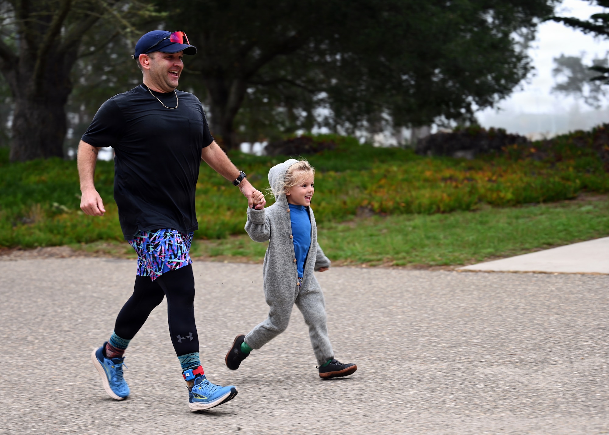 U.S. Space Force Capt. Cecil Guy, Space Launch Delta 30 Intercontinental Ballistic Missile test operator, runs across the finish line alongside his daughter during the localized T-Minus 10-Miler at Vandenberg Space Force Base