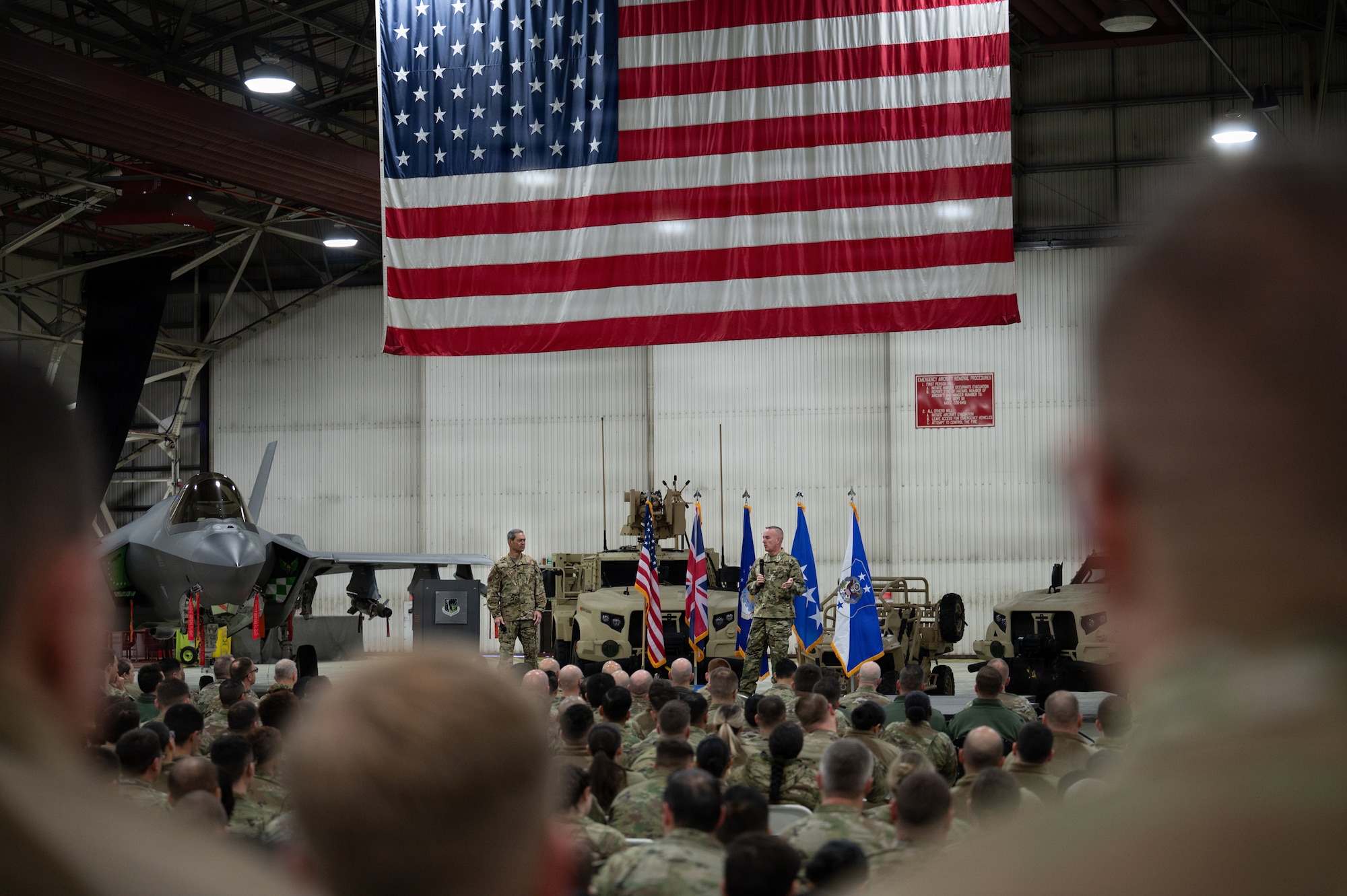 Air Force Chief of Staff Gen. Ken Wilsbach and Chief Master Sgt. of the Air Force David Wolfe address the room of 48th Fighter Wing airmen during a visit to RAF Lakenheath, England, Dec.19, 2025.
