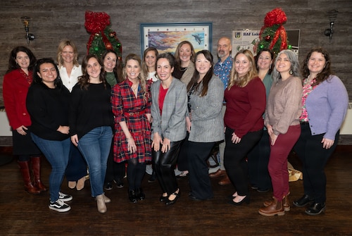 Mrs. Cindy Wilsbach, wife of Air Force Chief of Staff Gen. Ken Wilsbach, and Dr. Doniel Wolfe, wife of Chief Master Sgt. of the Air Force David Wolfe, pose for a photo alongside 48th Fighter Wing key spouse liaisons during a visit to RAF Lakenheath, England, Dec. 19, 2025.