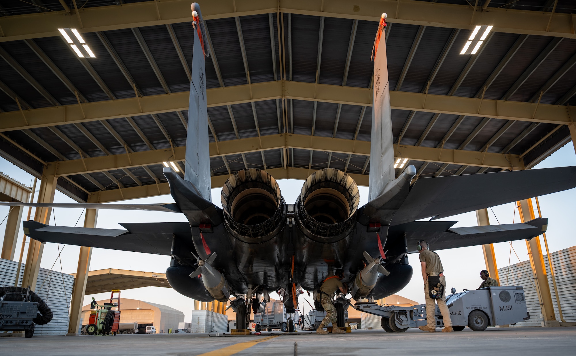 GBU-31 munition systems are loaded onto an F-15E Strike Eagle