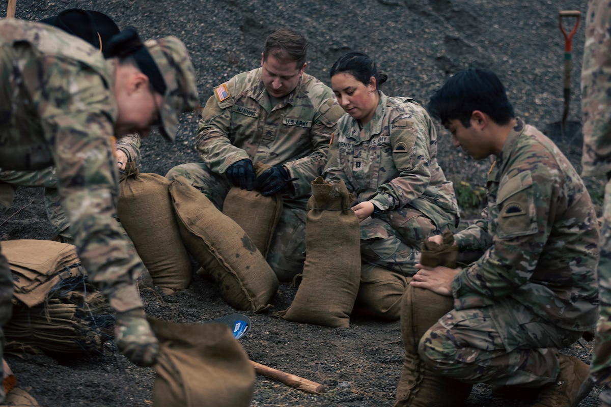 U.S. Army Soldiers from the 1st Squadron, 303rd Cavalry Regiment, 96th Troop Command, Washington Army National Guard fill sand bags in Sedro Woolley, Wash., Dec. 11, 2025
