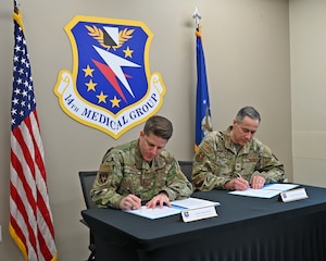 Commanders from the 14th FTW sign transition of MDG paperwork.