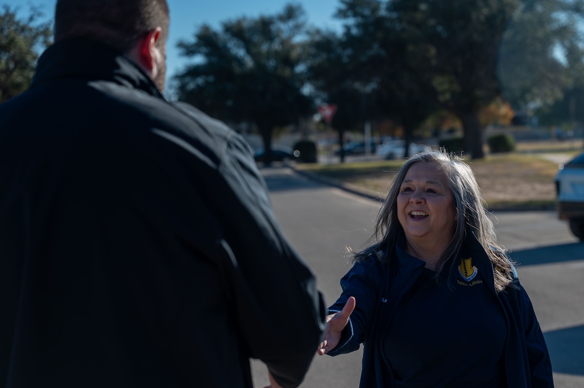 Alicia Aguilar, 17th Training Wing civic engagement coordinator, greets an honorary commander at the Goodfellow Medical Group, Goodfellow Air Force Base, Texas Dec. 12, 2025. The Honorary Commander Program pairs local civic leaders with installation commanders to foster mutual understanding, transparency and lasting partnerships between Goodfellow Air Force Base and the San Angelo community. (U.S. Air Force photo by Airman 1st Class James Salellas)