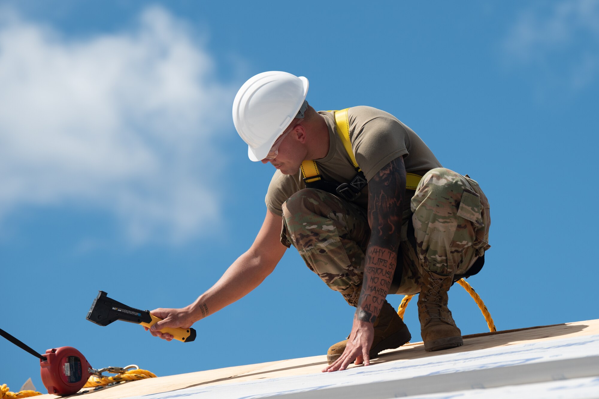 Staff Sgt. Nicholas Reed, a structural specialist with the Kentucky Air National Guard’s 123rd Civil Engineer Squadron, nails down roofing material during the construction of a joint operations center at Joint Base Pearl Harbor-Hickam, Hawaii, on July 29, 2025. Reed was among more than 70 personnel from the Louisville-based 123rd Airlift Wing to conduct annual training here over 14 days, honing skills that enhance their employment as Multi-Capable Airmen. (U.S. Air National Guard photo by Phil Speck)
