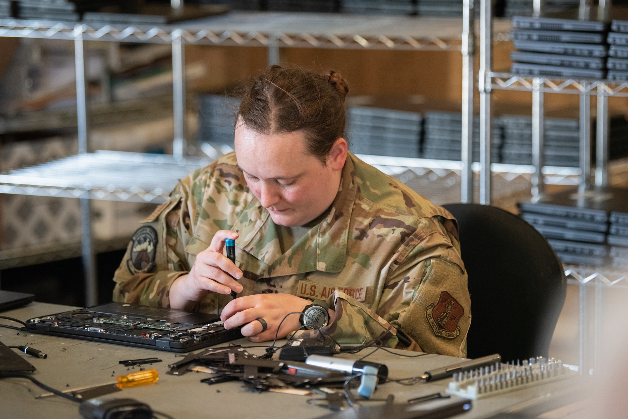 Tech. Sgt. Nathalie Rice, plans non-commissioned officer for the Kentucky Air National Guard’s 123rd Communication Squadron, preps a laptop for hardware upgrades at Joint Base Pearl Harbor-Hickam, Hawaii, on July 29, 2025. Rice was among more than 70 personnel from the Louisville-based 123rd Airlift Wing to conduct annual training here over 14 days, working with their counterparts from the active duty and Hawaii Air National Guard to enhance expeditionary skills and mission capabilities. (U.S. Air National Guard photo by Phil Speck)