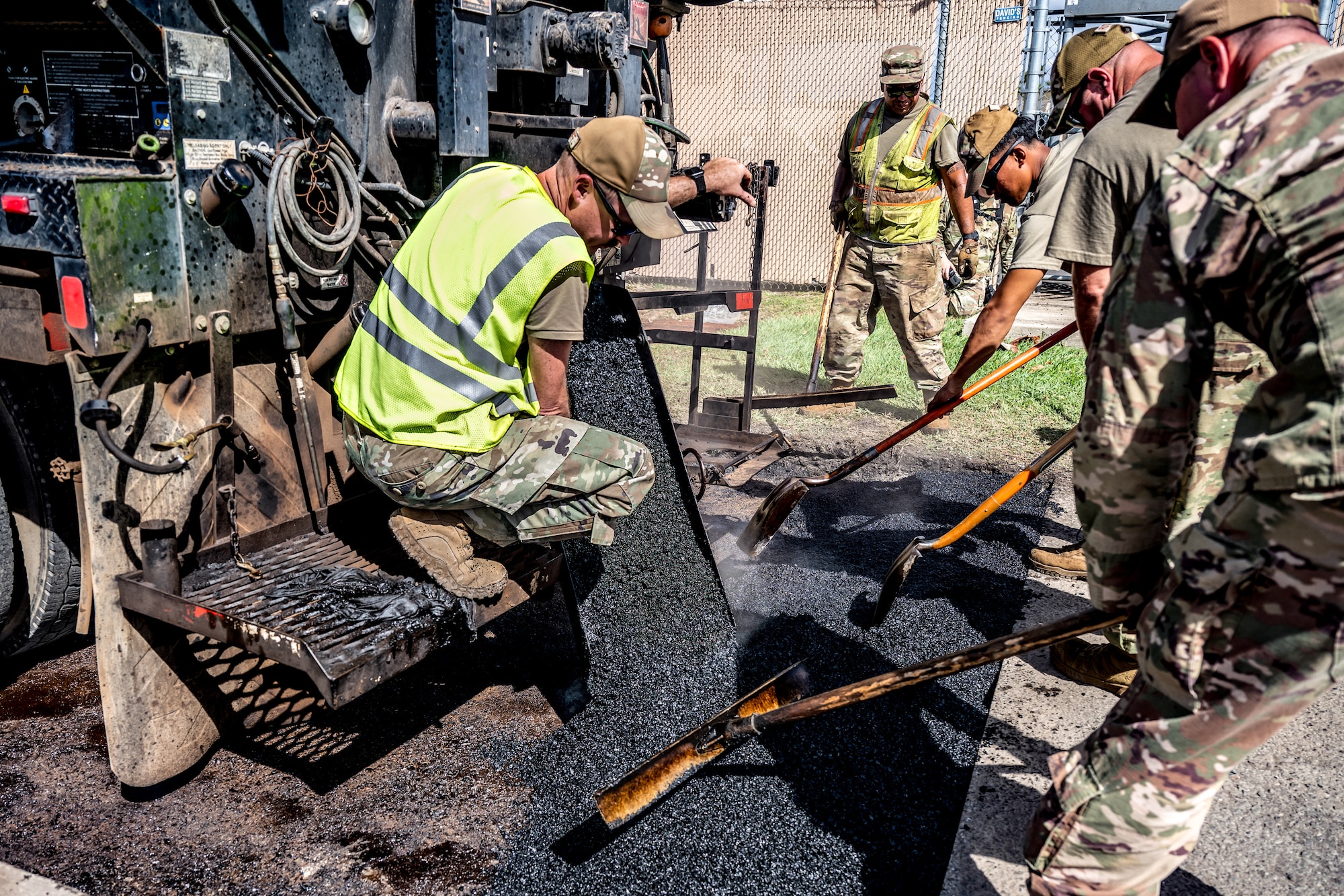 Airmen from the Kentucky Air National Guard’s 123rd Civil Engineer Squadron work with their active-duty counterparts from the 647th Civil Engineer Squadron to replace asphalt pavement at Joint Base Pearl Harbor-Hickam, Hawaii, on July 29, 2025. The Kentucky troops are among more than 70 personnel from the Louisville-based 123rd Airlift Wing to conduct annual training here over 14 days, sharpening skills that enhance their global employment as Multi-Capable Airmen. (U.S. Air National Guard photo by Dale Greer)