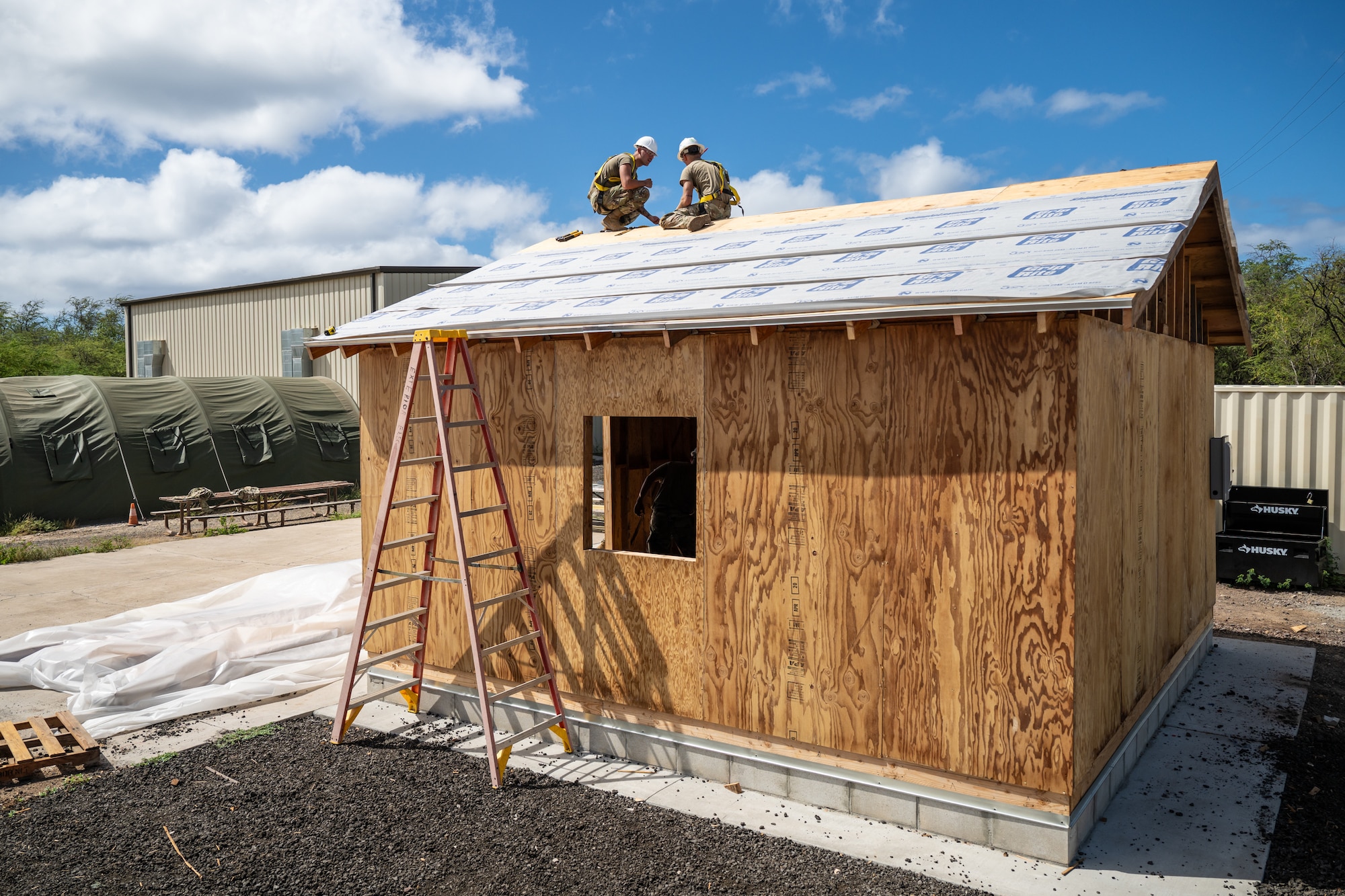 Airmen from the Kentucky Air National Guard’s 123rd Civil Engineer Squadron work with their active-duty counterparts from the 647th Civil Engineer Squadron to construct a Joint Operations Center for a contingency training site at Joint Base Pearl Harbor-Hickam, Hawaii, on July 29, 2025. The Kentucky troops were among more than 70 personnel from the Louisville-based 123rd Airlift Wing to conduct annual training here over 14 days, sharpening skills that enhance their employment as Multi-Capable Airmen. (U.S. Air National Guard photo by Dale Greer)