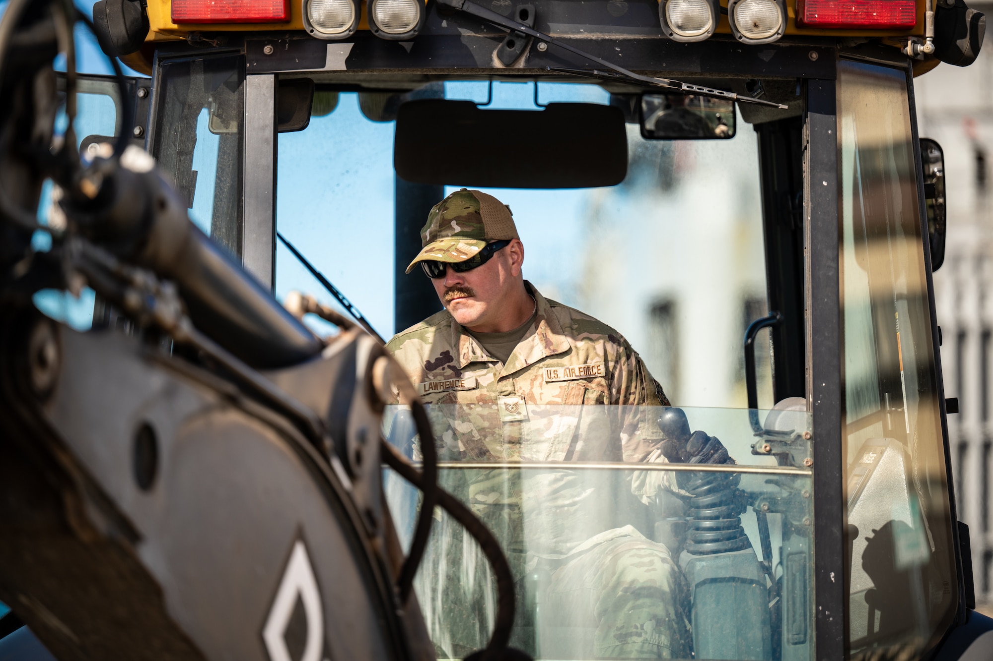 Tech. Sgt. Patrick Lawrence, a construction specialist from the Kentucky Air National Guard’s 123rd Civil Engineer Squadron, operates a backhoe to repair pavement at Joint Base Pearl Harbor-Hickam, Hawaii, with help from his active-duty counterparts at the 647th Civil Engineer Squadron on July 29, 2025. Lawrence is among more than 70 Airmen from the Louisville-based 123rd Airlift Wing to conduct annual training here over 14 days, sharpening skills that enhance their global employment as Multi-Capable Airmen. (U.S. Air National Guard photo by Dale Greer)