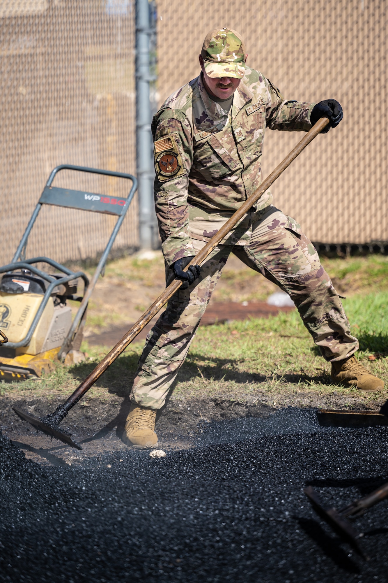 Tech. Sgt. Patrick Lawrence, a construction specialist from the Kentucky Air National Guard’s 123rd Civil Engineer Squadron, spreads asphalt pavement at Joint Base Pearl Harbor-Hickam, Hawaii, on July 29, 2025. Lawrence is among more than 70 Airmen from the Louisville-based 123rd Airlift Wing to conduct annual training here over 14 days, sharpening skills that enhance their global employment as Multi-Capable Airmen. (U.S. Air National Guard photo by Dale Greer)