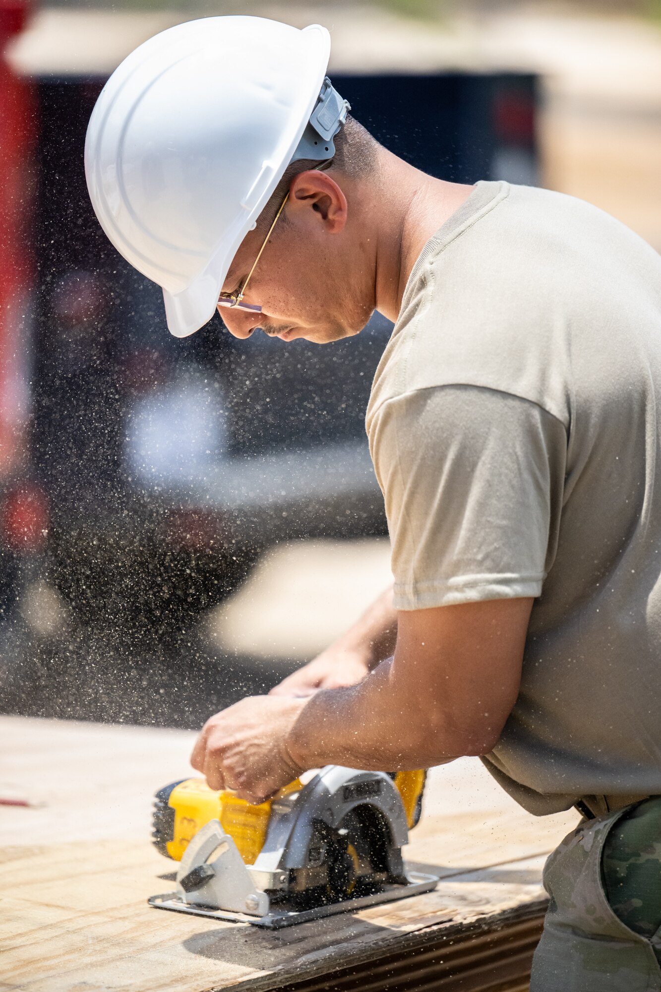 Senior Airman Elmer Lopez-Duran, a structures specialist with the Kentucky Air National Guard’s 123rd Civil Engineer Squadron, cuts lumber for the construction of a Joint Operations Center on a contingency training site at Joint Base Pearl Harbor-Hickam, Hawaii, on July 29, 2025. Lopez-Duran is among more than 70 Airmen from the Louisville-based 123rd Airlift Wing to conduct annual training here over 14 days, sharpening skills that enhance their employment as Multi-Capable Airmen. (U.S. Air National Guard photo by Dale Greer)